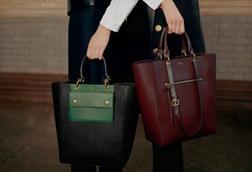Two models shown from waist down holding green and red Mulberry bags