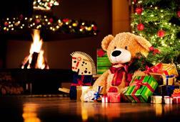 Teddy-bear,-rocking-horse-and-gifts-under-Christmas-tree