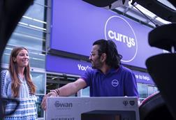 Currys employee loading product into car boot for customer