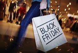 Lady holding a black Friday shopping bag