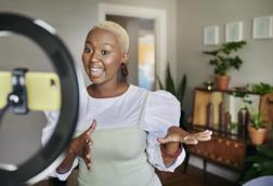 Influencer with ring light and camera phone