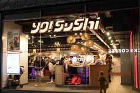Exterior of Yo! Sushi store showing people eating inside