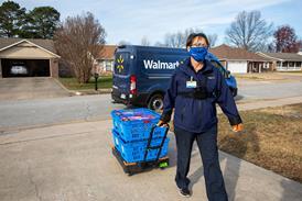 Walmart driver walks up customer's driveway with shopping