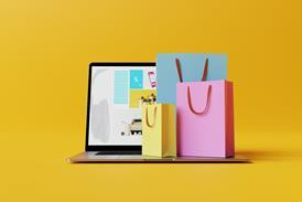 Laptop with the website of the online store and shopping bags
