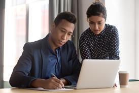 Black and Asian lawyers working at a desk
