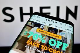Shein website on phone against Shein background