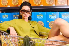 Model posing in front of cereal aisle