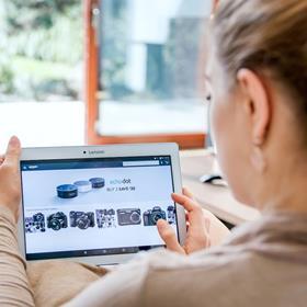 Woman carrying out online shopping on her tablet