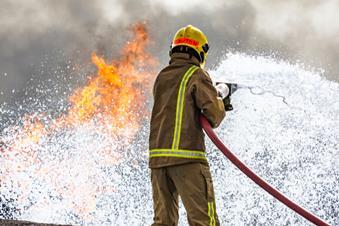Firefighter putting out blaze