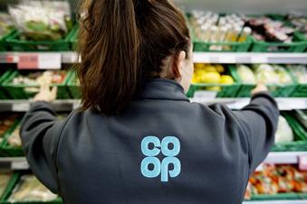 Co-op employee in grocery section, shown from behind