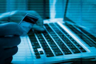 Computer code over a credit card and a laptop