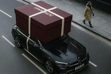 A giant Lookfantastic gift box on roof of an Uber Eats delivery car
