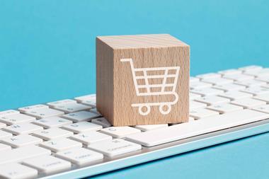 Wooden box illustrated with a shopping trolley sat on keyboard