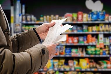 Customer reading grocery shopping receipt