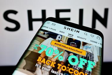 Shein website on phone with Shein logo in background
