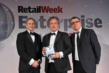 Nick Wheeler collects  the Retailer of the Year award from Retail Week editor-in-chief Chris Brook-Carter (left) and Enterprise Awards host Sean Collins