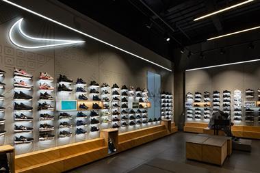 Interior of Nike store showing trainers on display