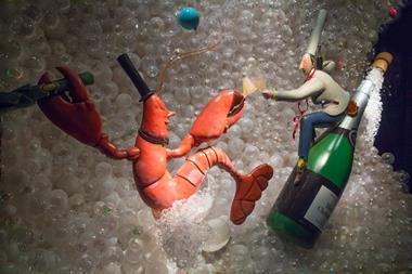 The lobster and the chef share a bottle of champagne in another colourful 3D display.