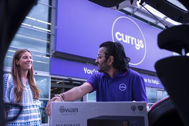 Currys colleague lifts boxed item for customer