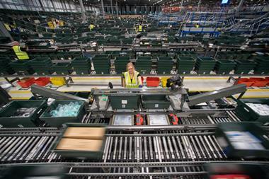 A staff member oversees orders at John Lewis's Magna Park distribution centre