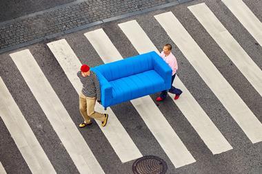 Customers carrying secondhand Ikea sofa