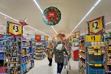 Supermarket aisles at Christmas, showing shoppers and promotional decorations