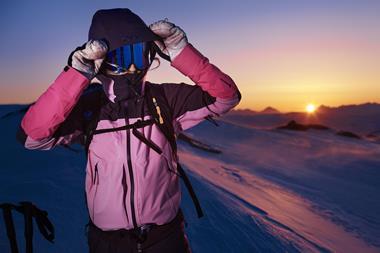 Model wearing Peak Performance skiwear outdoors