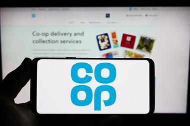 Co-op logo on phone held up against background of Co-op website