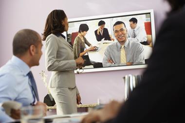 Staff in a boardroom getting video training