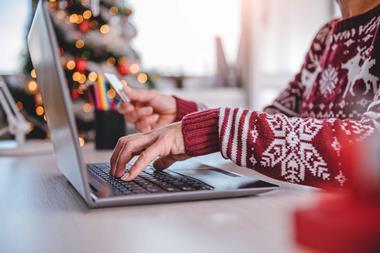 Woman-shopping-online-wearing-Christmas-jumper