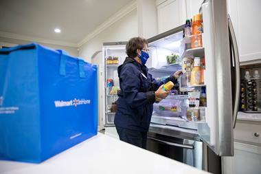 Walmart InHome delivery service - woman putting groceries in fridge