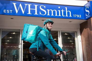 Deliveroo rider outside a WHSmith store