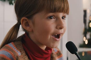 Still from Sainsbury's ad showing little girl on supermarket tannoy