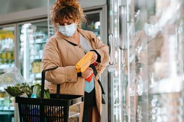 Woman wearing face mask shopping in supermarket