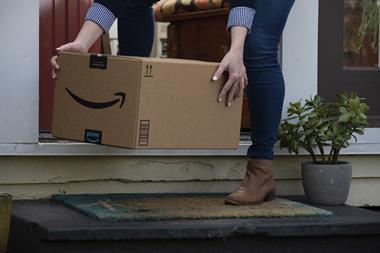 Woman picking up Amazon box