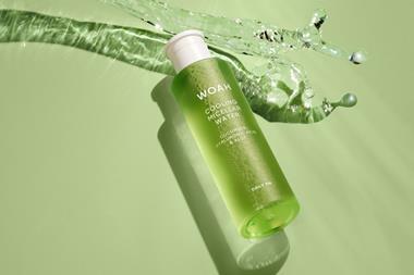 Close-up product shot of Next Woah Cooling Micellar Water on a green background