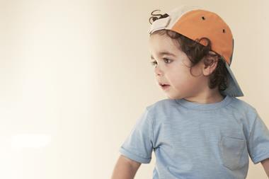 Child wearing Kidly t-shirt and cap