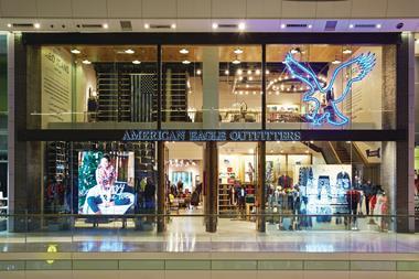 In the Westfield London store a vast blue neon eagle dominates the high glass frontage, drawing the eye upwards so the shopper gets a view of both floors and the staircase that connects them.