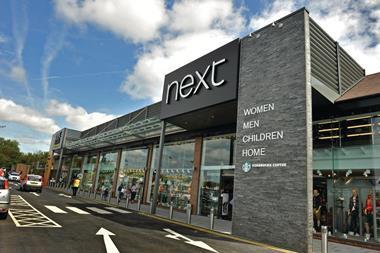 Next has reduced its profit expectations for the year after the unseasonably warm start to autumn hit sales growth in its third quarter.