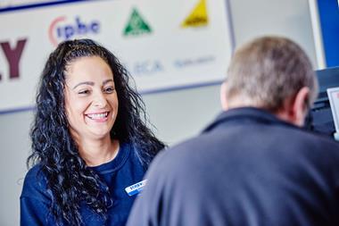 Screwfix employee smiling at customer in store