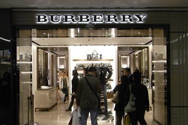 Luxury brand Burberry has warned that volatile exchange rates could hit full year profits as it revealed a quarterly sales rise.