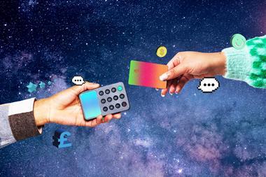Hand extending card to chip and pin device against background of stars
