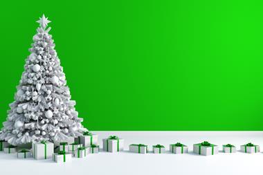 Christmas tree with presents underneath against green background