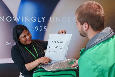Uber Eats rider collecting a bag of John Lewis products
