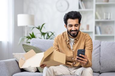 Man opening delivery box at home
