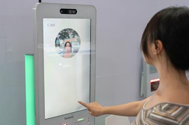 Female customer using facial recognition technology