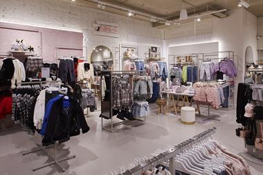 Interior of River Island Boutique in Porstmouth, showing kidswear for girls on racks