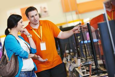 Colleague and customer in electricals shop
