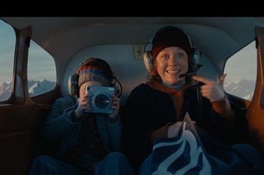 Still from Boots Christmas advert for 2023 featuring a mother and a child with a camera heading to North Pole