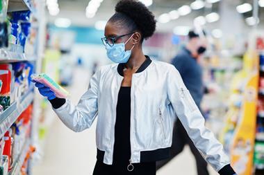 Shopper looking at goods while wearing a face mask